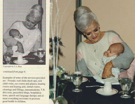 Rose Mofford holding a baby with a page from a document that included the picture
